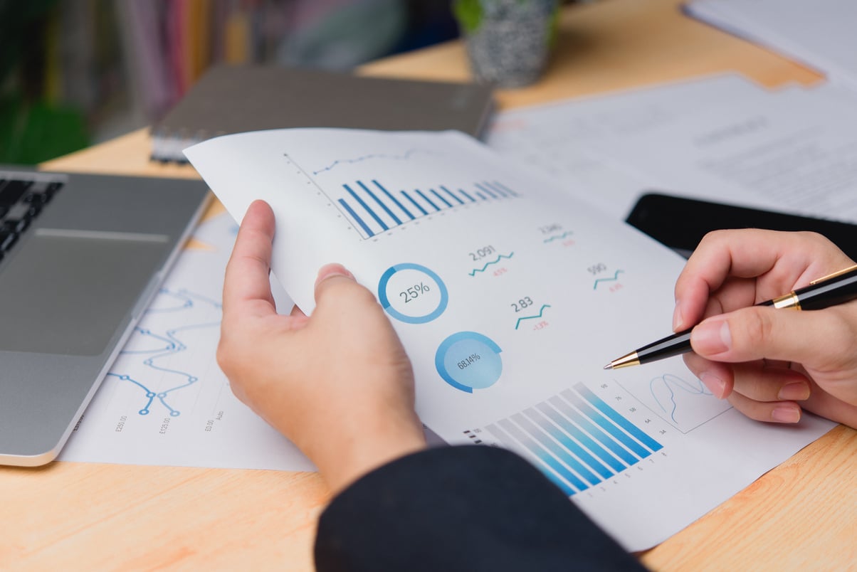 Close-up of a professional hand reviewing business document data